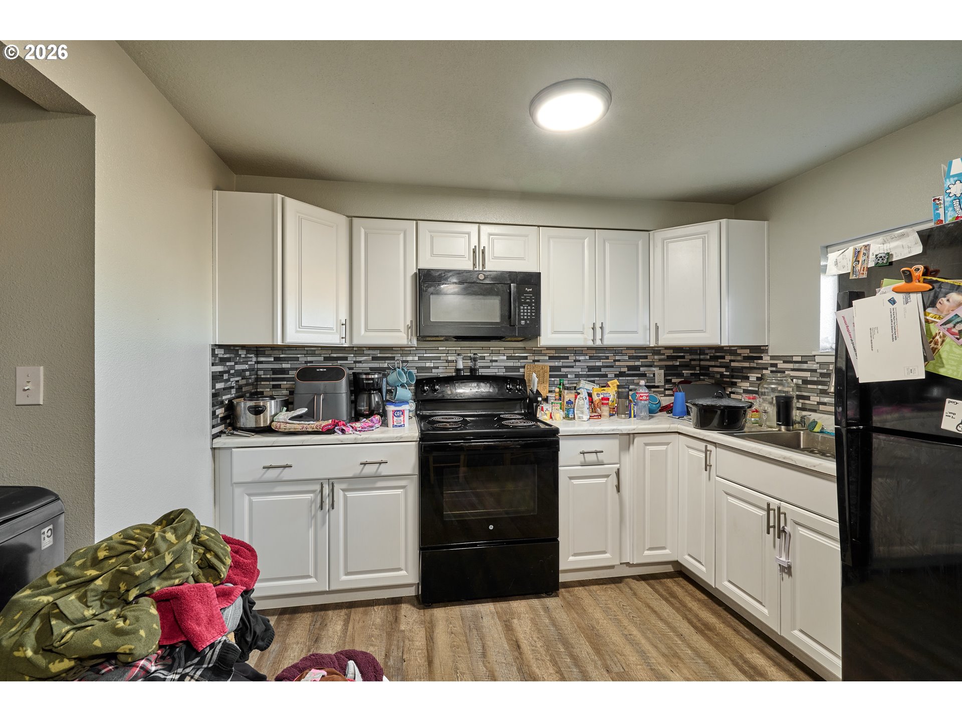 880 North Pershing Street Mount Angel, OR 97362 - Photo 19 of 30 a kitchen with a stove a sink and a microwave