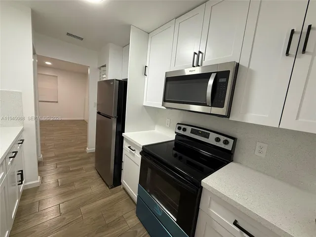 a kitchen with a refrigerator stove and microwave