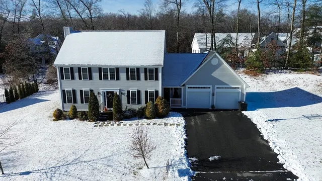 an aerial view of a house with yard and green space