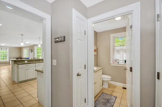 a bathroom with a granite countertop tub sink and mirror
