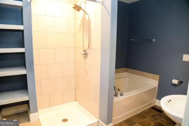 a bathroom with a tub and toilet