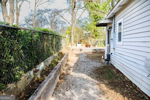a view of a yard with wooden fence