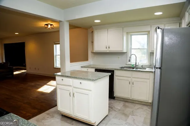 a kitchen with a stove cabinets and a refrigerator