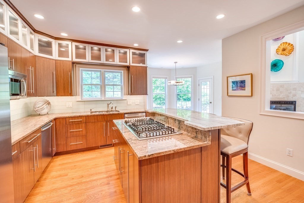 51 Linseed Road Northampton, MA 01060 - Photo 17 of 42 a kitchen with stainless steel appliances granite countertop a stove a sink dishwasher and cabinets with wooden floor