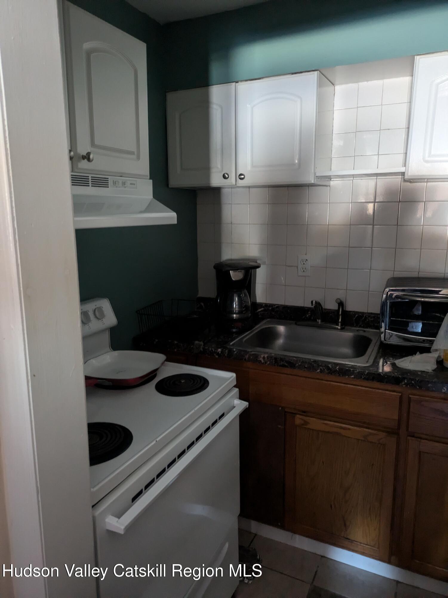 57 Samsonville Road Kerhonkson, NY 12446 - Photo 13 of 25 a kitchen with a sink and cabinets