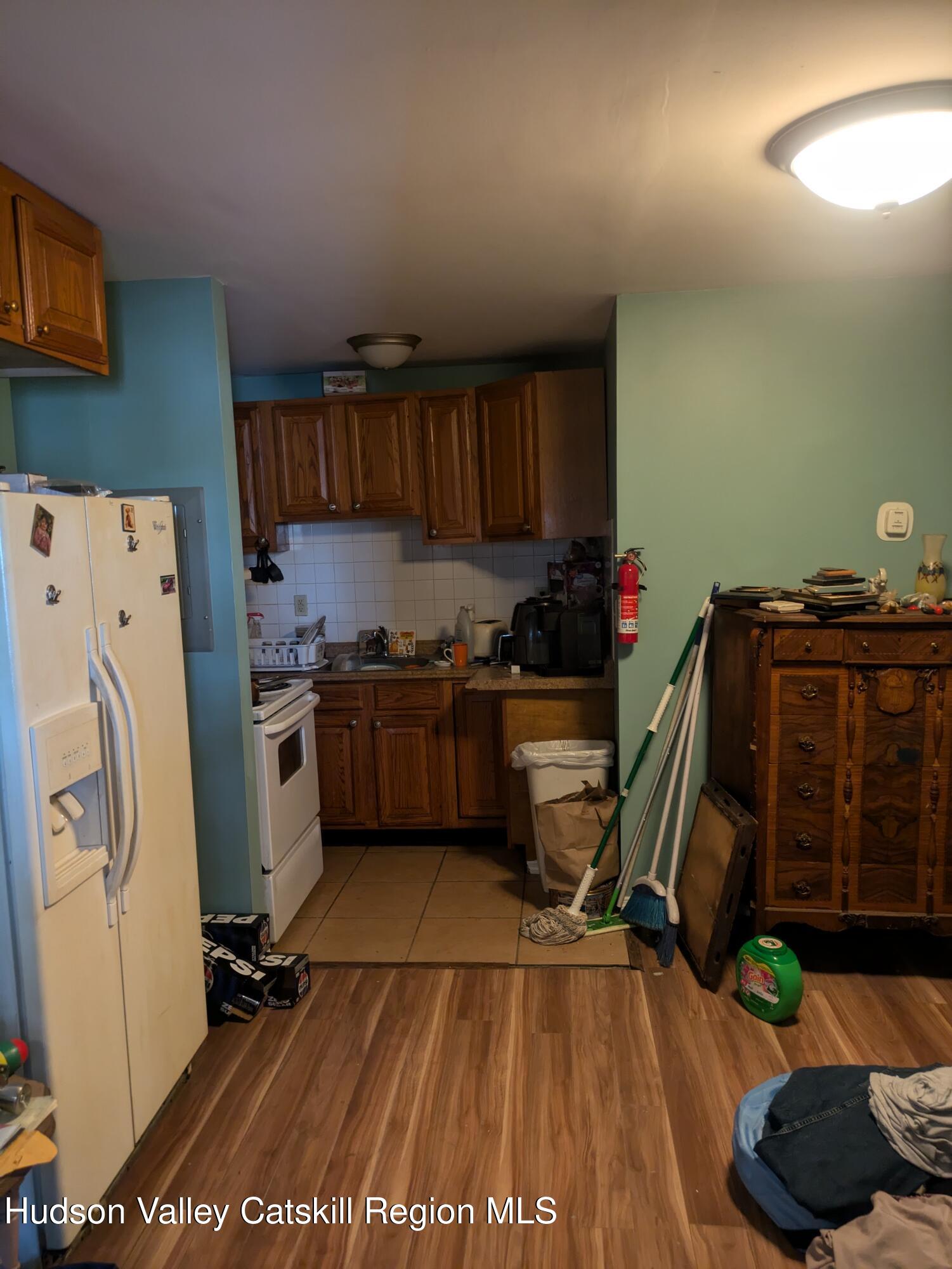 57 Samsonville Road Kerhonkson, NY 12446 - Photo 16 of 25 a kitchen with a refrigerator and cabinets