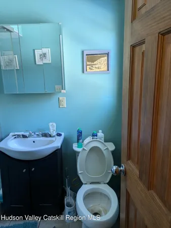 a bathroom with a toilet sink and mirror