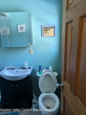 a bathroom with a toilet sink and mirror