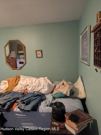 a bed sitting in a bedroom next to a window