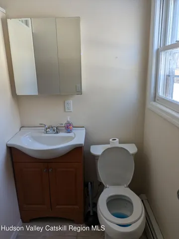 a bathroom with a toilet a sink and a mirror
