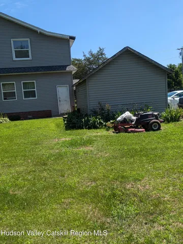 a view of house with backyard