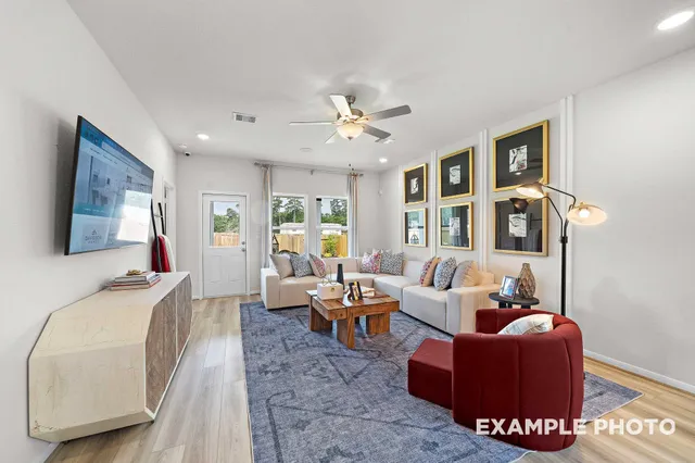 a living room with furniture and wooden floor