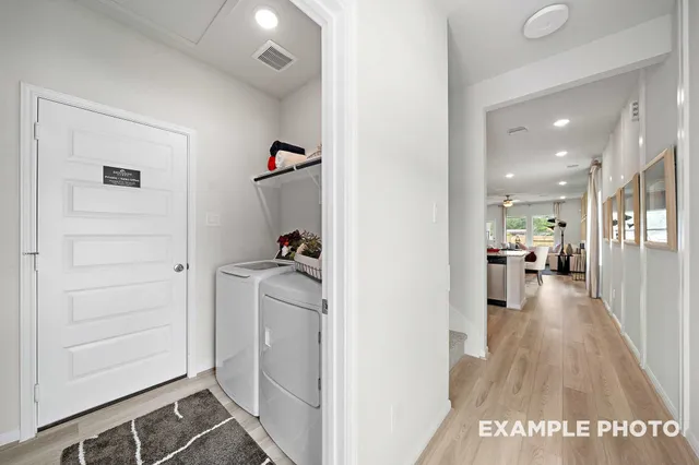a view of a hallway with wooden floor windows and livingroom