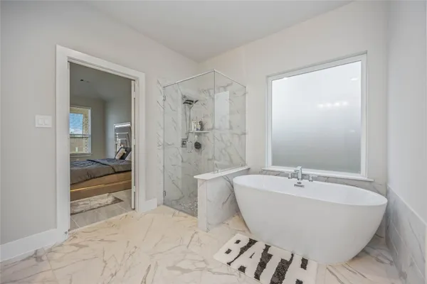 a spacious bathroom with a shower sink and mirror