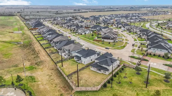 an aerial view of residential houses with outdoor space