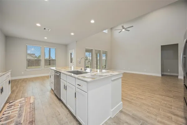 a large kitchen with stainless steel appliances granite countertop a stove and a sink