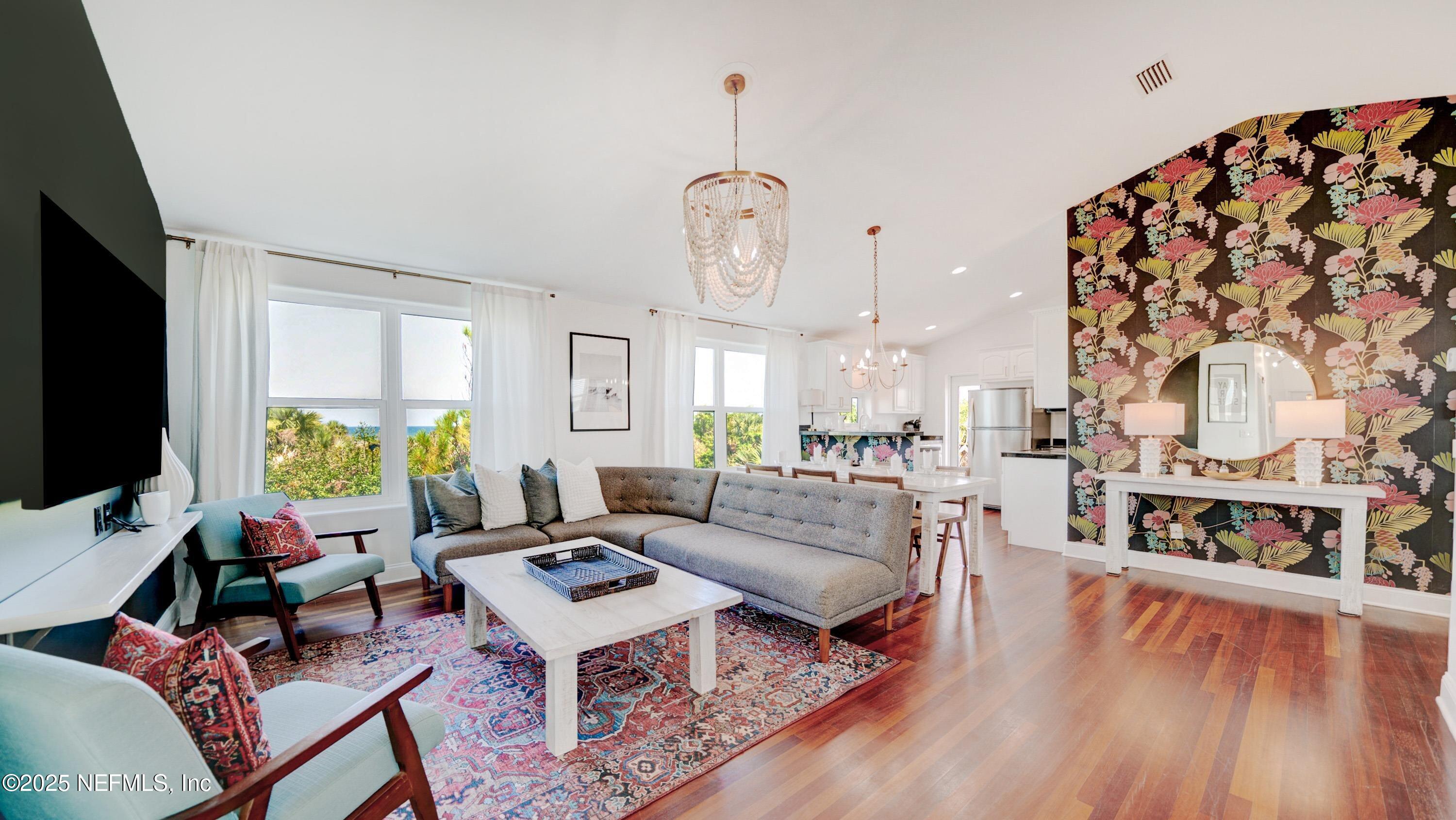 670 A1A Beach Boulevard, Unit D St. Augustine Beach, FL 32080 - Photo 1 of 1 a living room with fireplace furniture and a flat screen tv