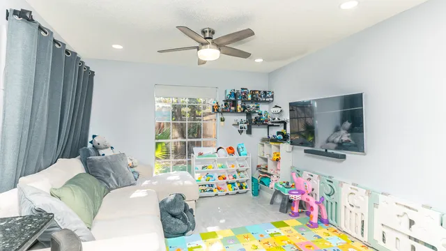 a children room with furniture and a flat screen tv