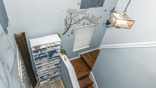 a view of a staircase with wooden floor