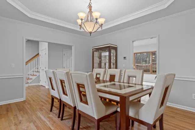 a view of a dining room with furniture wooden floor and chandelier