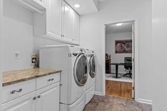 a utility room with sink dryer and washer