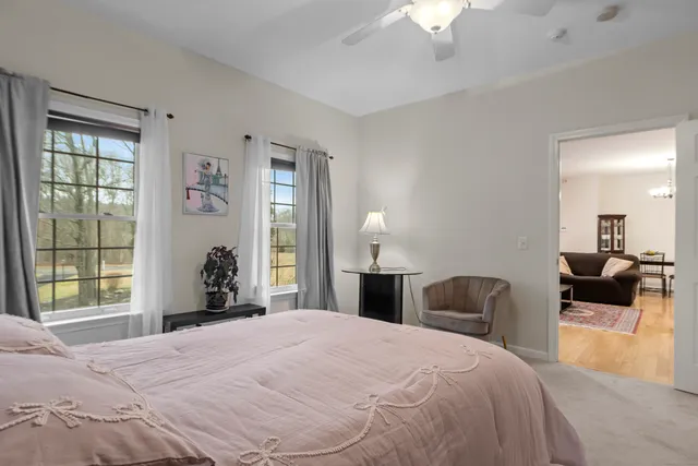 a bedroom with a bed and a large window