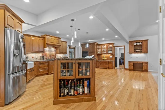 a open kitchen with stainless steel appliances granite countertop a refrigerator and stove