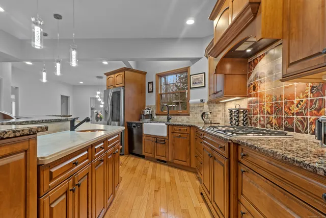 a kitchen with a sink stove and cabinets
