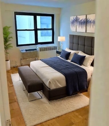 350 West 51st Street, Unit 3H Manhattan, NY 10019 - Photo 4 of 8 a bedroom with a bed and window