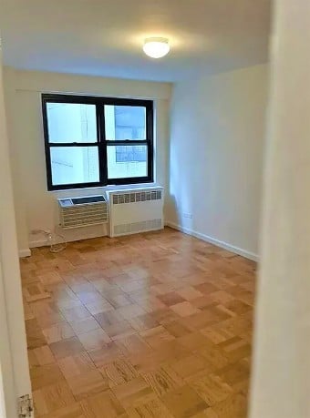 350 West 51st Street, Unit 3H Manhattan, NY 10019 - Photo 5 of 8 a view of an empty room with a window