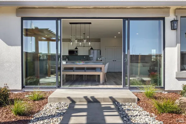 a living room with a fireplace and a floor to ceiling window