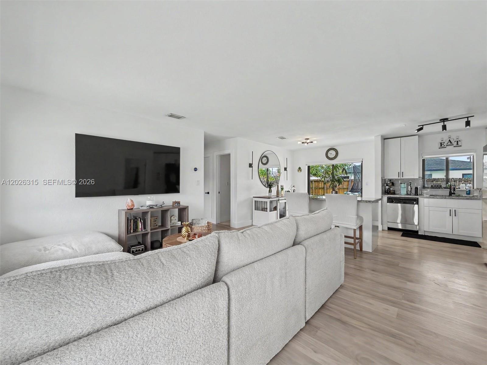 10762 Southwest 145th Street Miami, FL 33176 - Photo 20 of 28 a living room with furniture and a flat screen tv