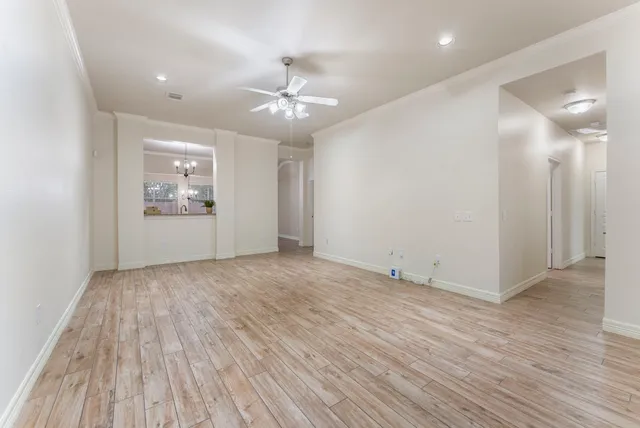 a kitchen with stainless steel appliances granite countertop a sink a stove refrigerator and island with wooden floor