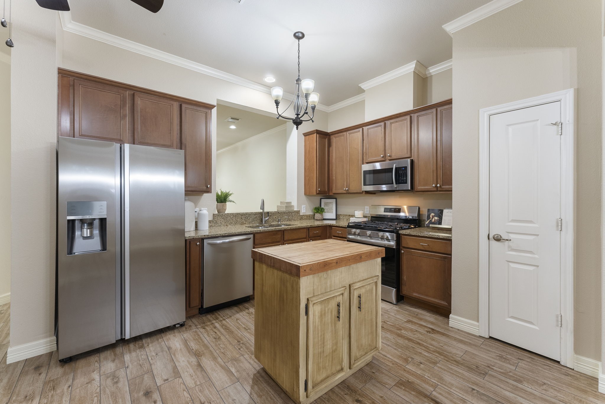 9622 Old Timber Lane Spring, TX 77379 - Photo 19 of 50 a kitchen with stainless steel appliances granite countertop a refrigerator a stove a sink and a center island with wooden floor