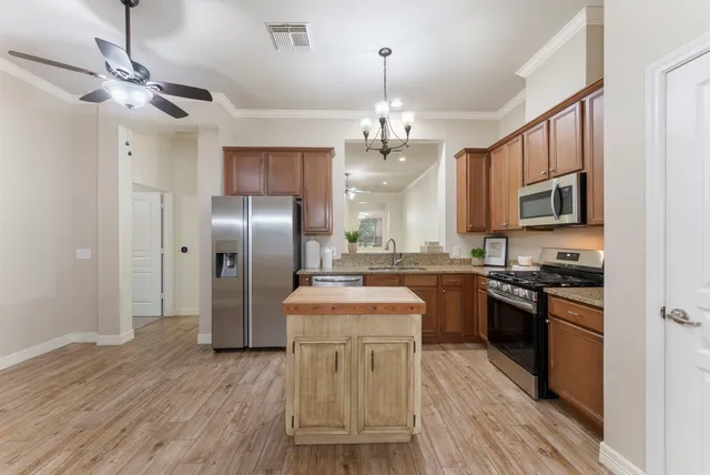 a spacious bathroom with a granite countertop sink a mirror and a shower