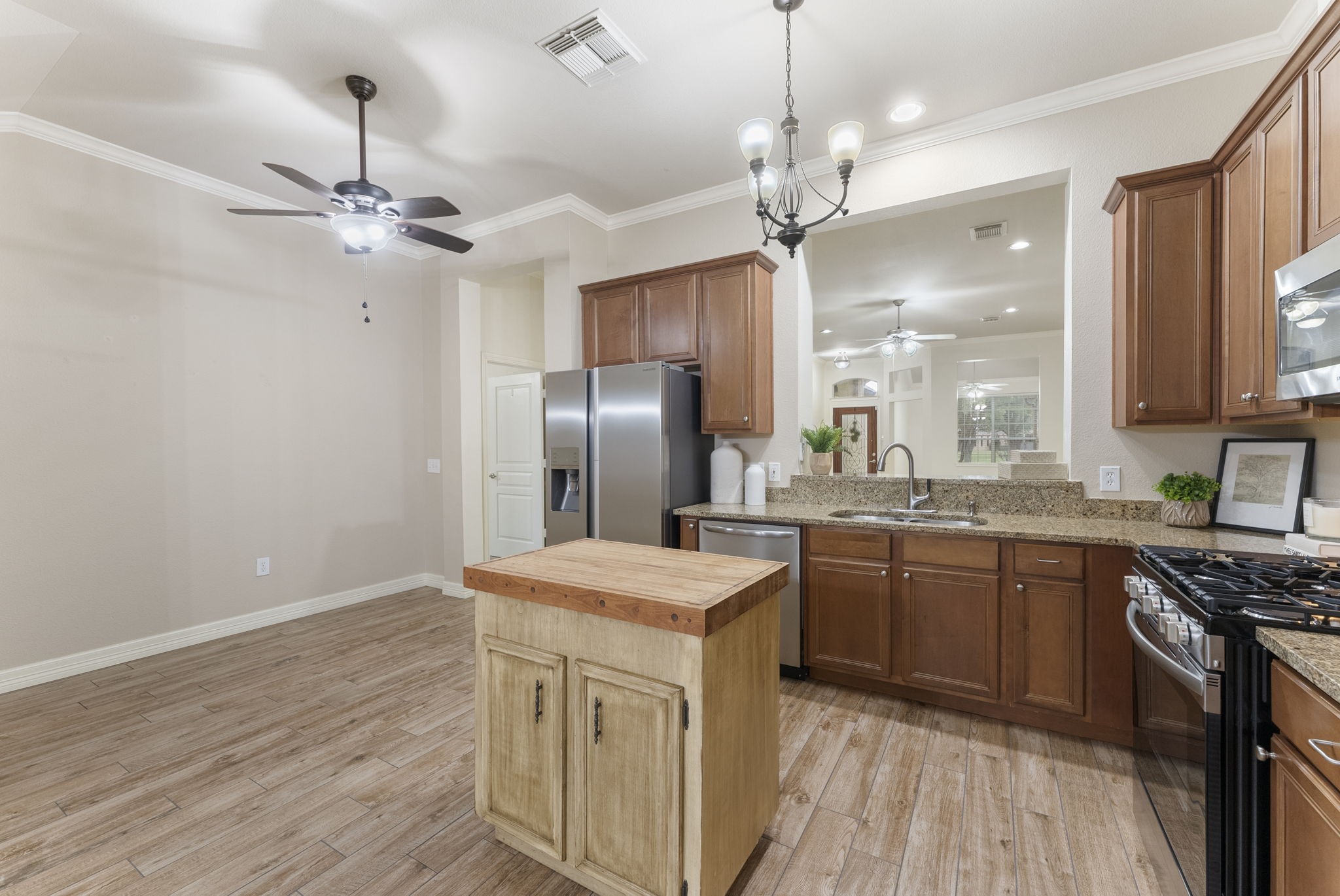 9622 Old Timber Lane Spring, TX 77379 - Photo 21 of 50 a kitchen with stainless steel appliances granite countertop a sink a stove refrigerator and island with wooden floor