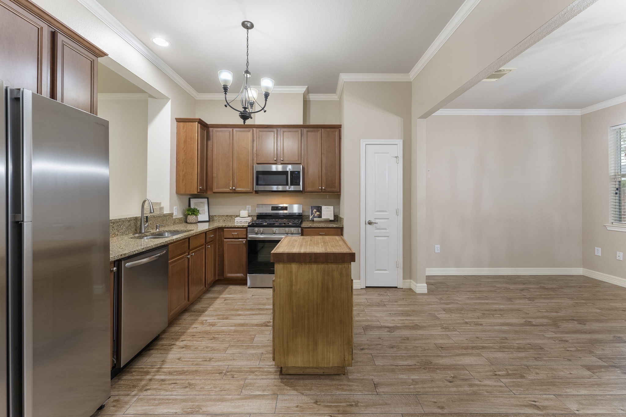 9622 Old Timber Lane Spring, TX 77379 - Photo 24 of 50 a kitchen with kitchen island granite countertop stainless steel appliances cabinets a sink and a counter top space