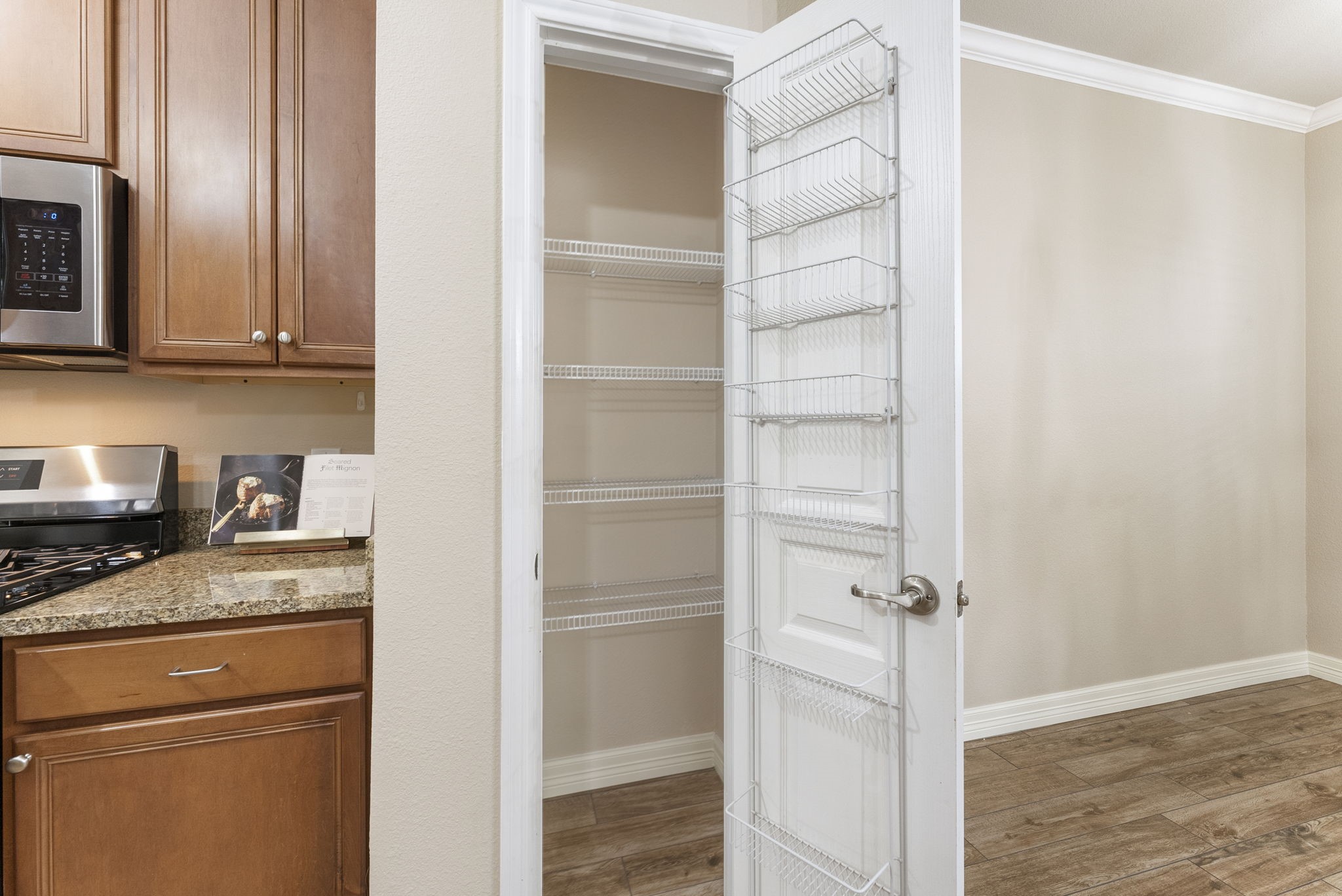 9622 Old Timber Lane Spring, TX 77379 - Photo 28 of 50 a kitchen with a refrigerator and a stove top oven