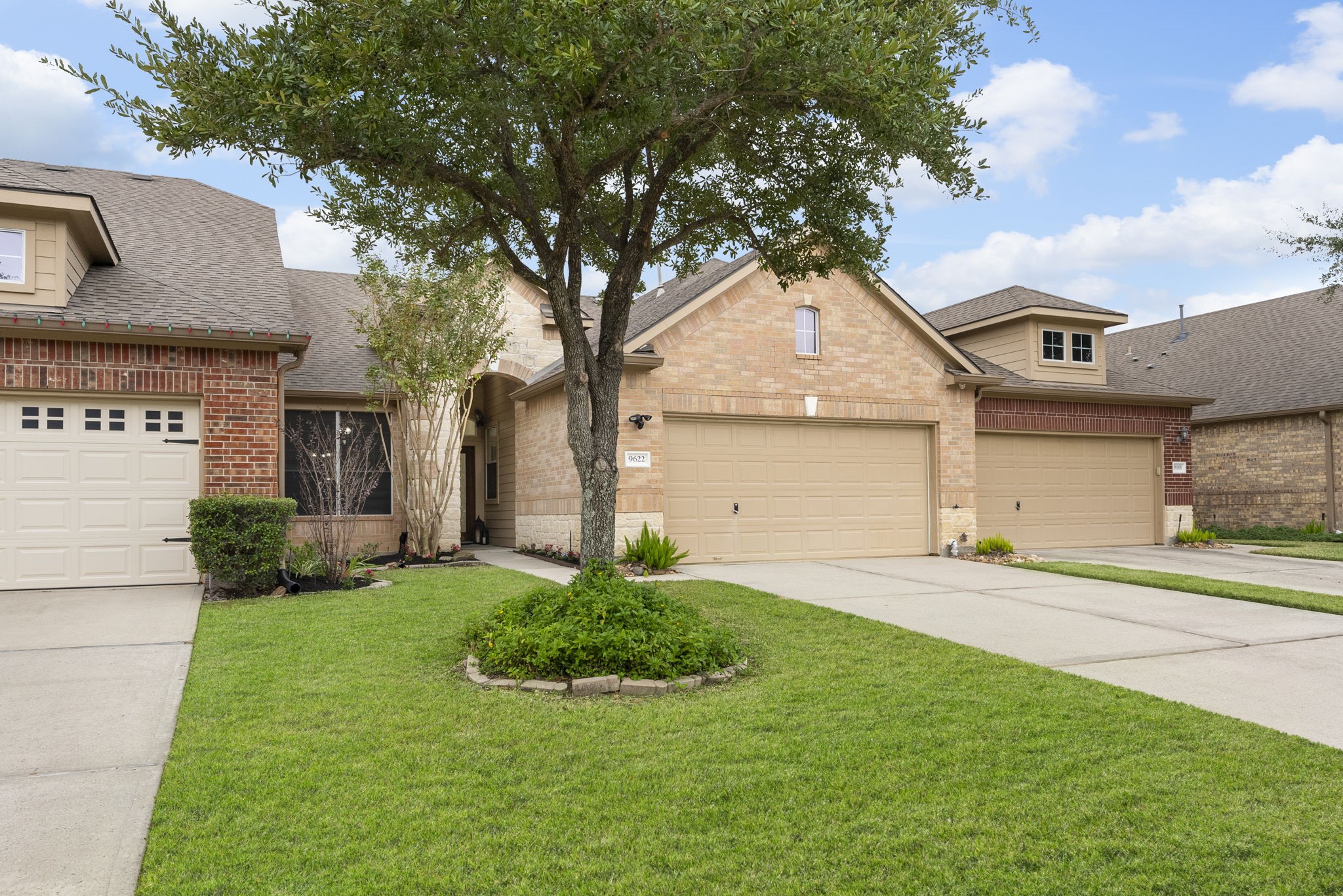9622 Old Timber Lane Spring, TX 77379 - Photo 2 of 50 a front view of a house with a yard and garage