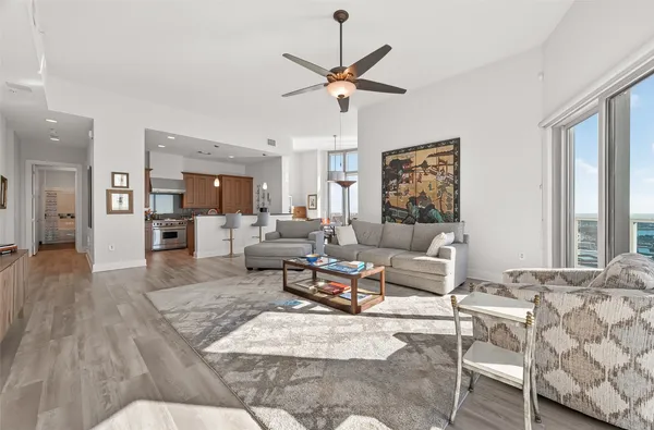 a living room with furniture and a floor to ceiling window