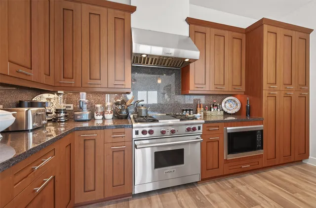 a kitchen with stainless steel appliances granite countertop a refrigerator stove and sink