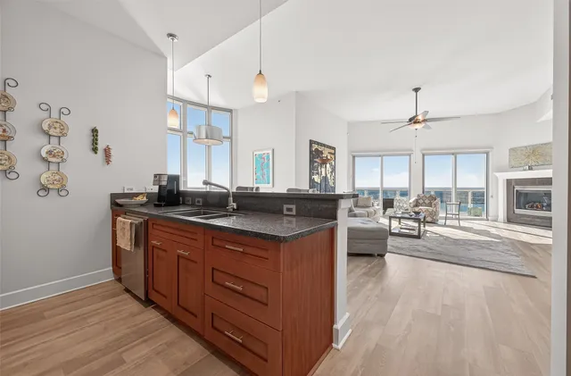a bedroom with a bed dresser and a large window