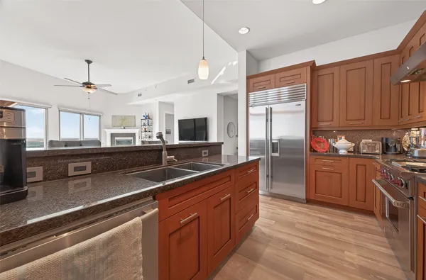 a bedroom with a bed and a dresser next to a window