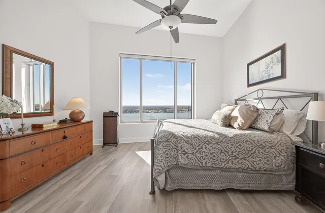 a bathroom with a granite countertop double vanity sink a mirror and a toilet