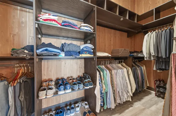 a bathroom with a granite countertop sink a mirror a toilet a bathtub and shower