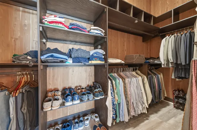 a bathroom with a granite countertop sink a mirror a toilet a bathtub and shower