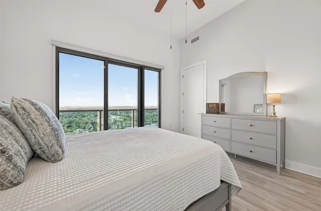 a living room with furniture and a floor to ceiling window