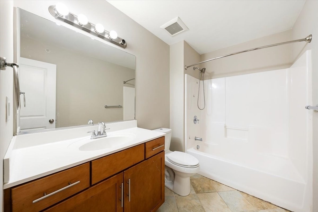 6 Bates Street, Unit A Devens, MA 01434 - Photo 27 of 41 a bathroom with a sink a toilet and shower