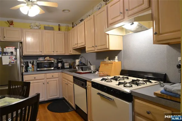 a kitchen with a stove and a white cabinets