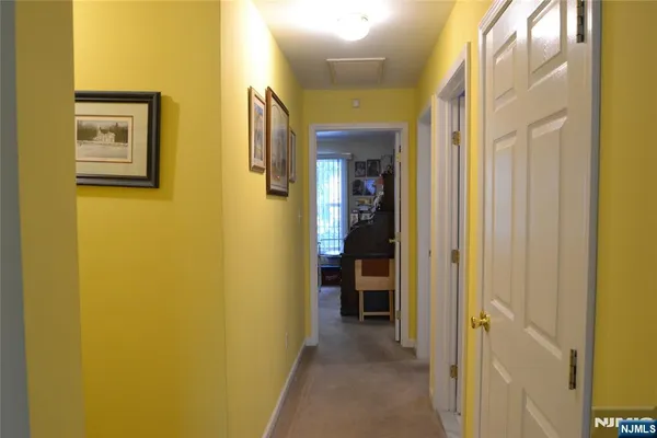 a view of a hallway with wooden shelves